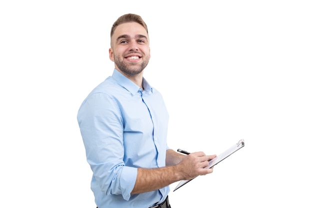 a guy in a blue shirt writes in a notebook on a white background