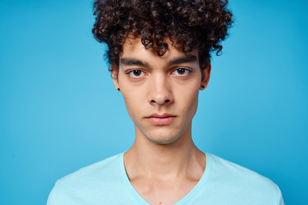 Photo guy in blue tshirt curly hair cropped view isolated background