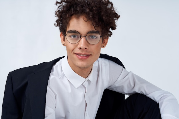 Guy curly hair glasses and jacket photography studio model light background Copy Space