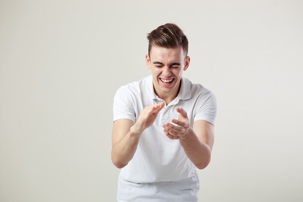 Guy dressed in a white t-shirt and jeans nickers on a white background in the studio .