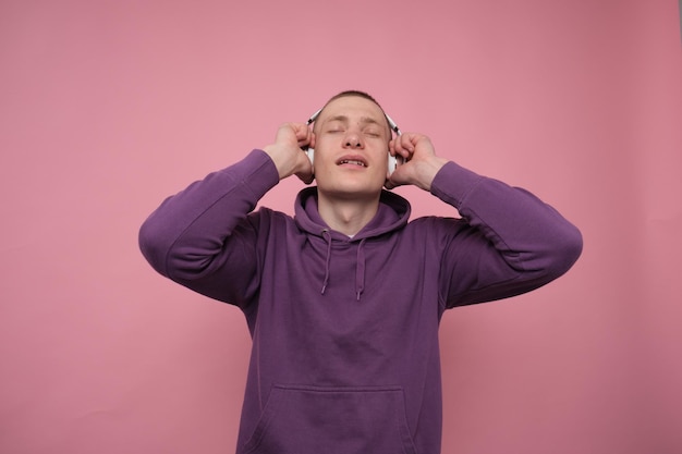 guy enjoying and listening to music in headphones with his eyes closed