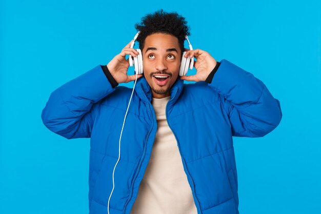 Guy enjoying nice soft sound of new headphones parents bought for christmas