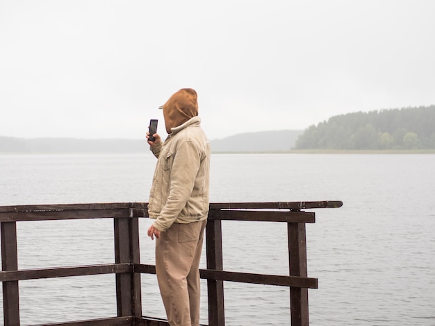 Guy enjoying a rainy day on the pier