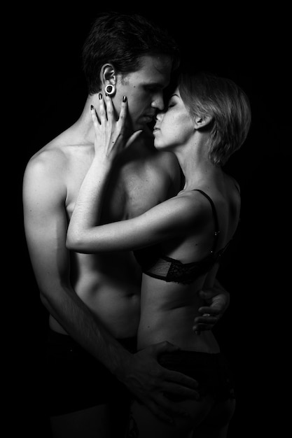 Photo guy and girl are standing in an embrace, black and white photo