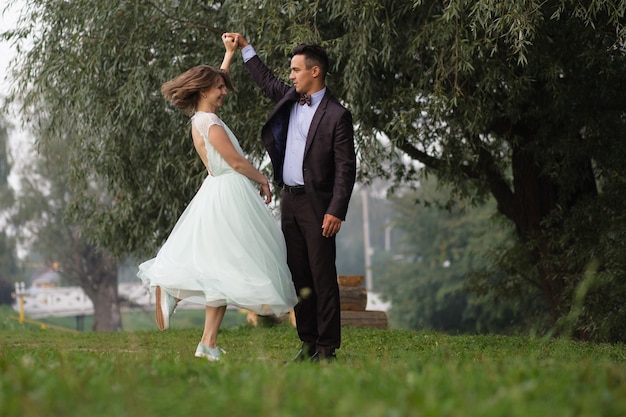 Guy and girl dancing in nature