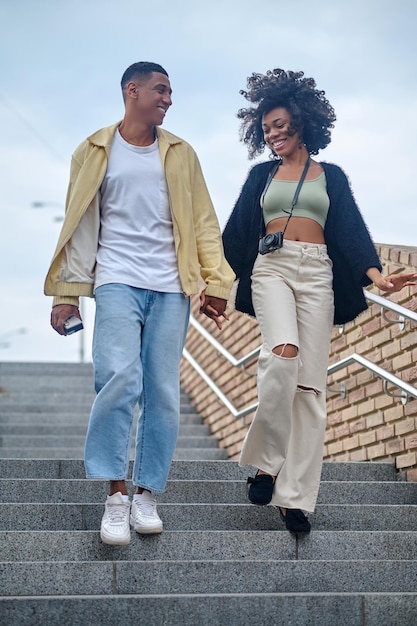 Guy and girl going down stairs on street