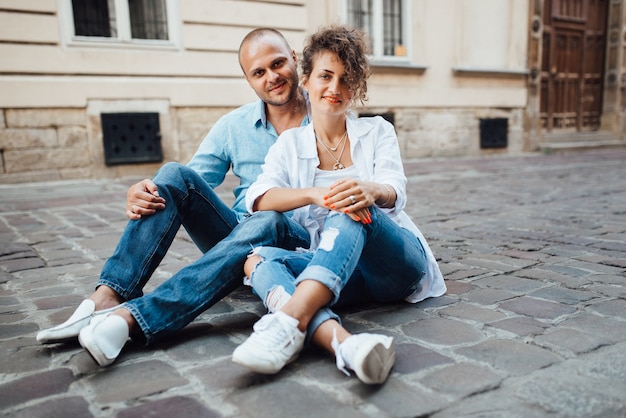 Guy and a girl happily walk in the morning on the empty streets of old Europe