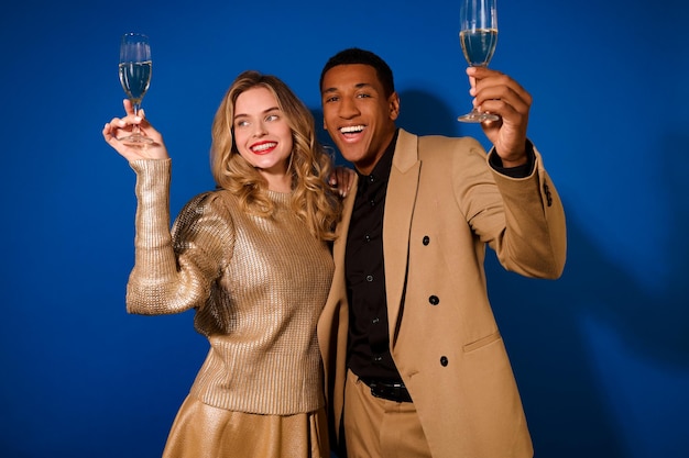 Guy and girl hugged raising glasses of champagne