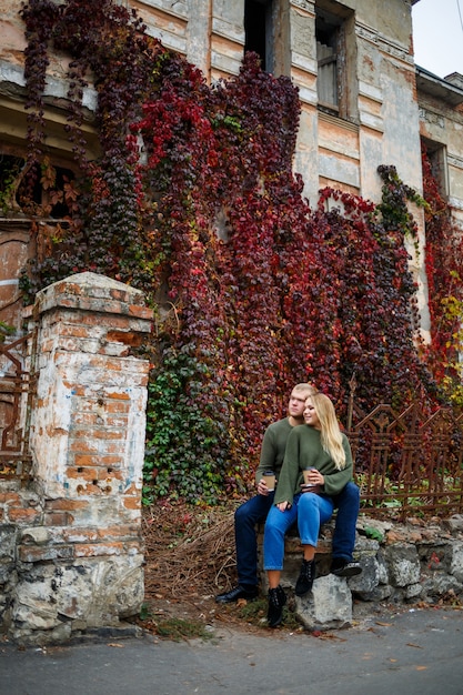 Guy and girl in jeans and green sweaters