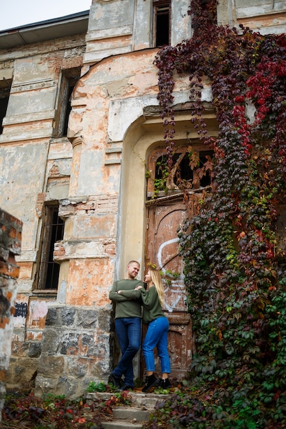 Guy and girl in jeans and green sweaters