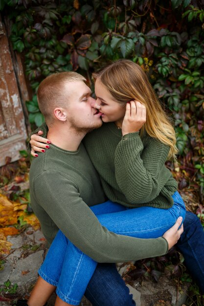 Guy and girl in jeans and green sweaters