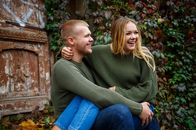 Guy and girl in jeans and green sweaters