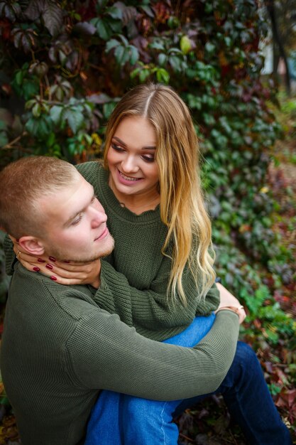 Guy and girl in jeans and green sweaters