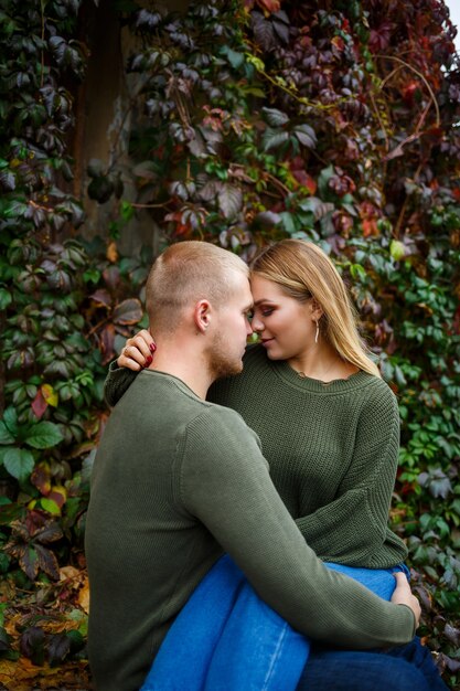 Guy and girl in jeans and green sweaters