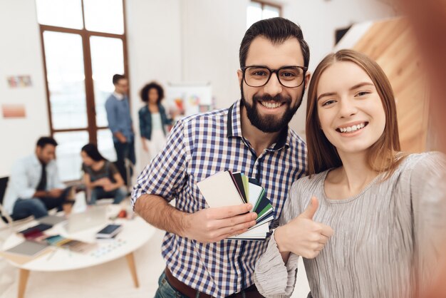 A guy and a girl do selfie on a smartphone.