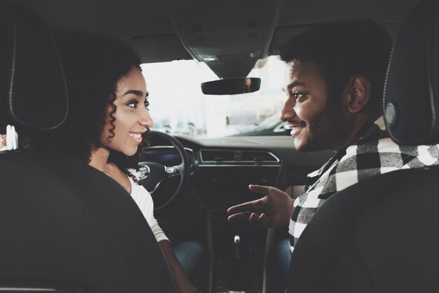 Guy and Girl Talk inside Car Choosing Vehicle