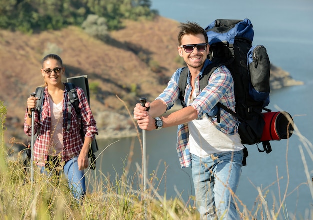 The guy and the girl traveling in the mountains.