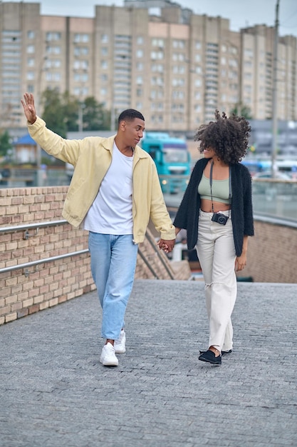 Guy and girl walking looking at each other