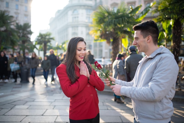 Guy giving a flower to his girlfriend