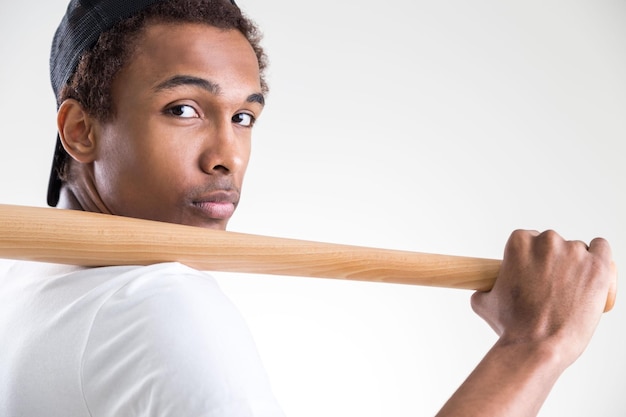 Guy holding bat closeup