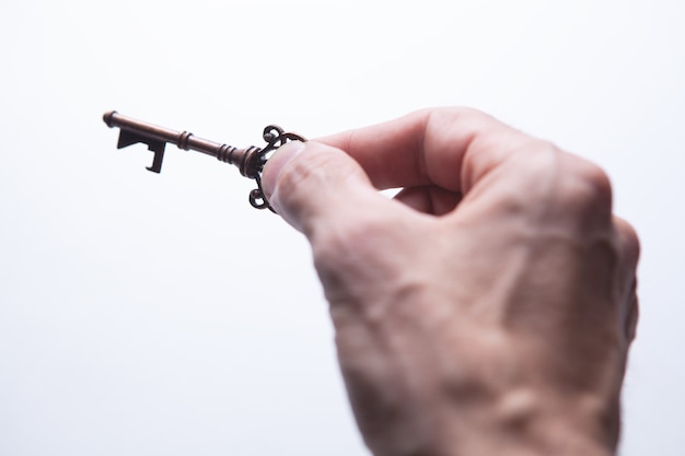 A guy holding an old key