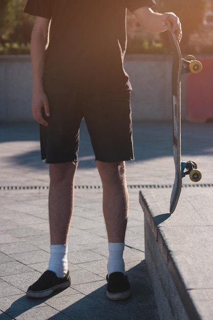 Guy holding skateboard.