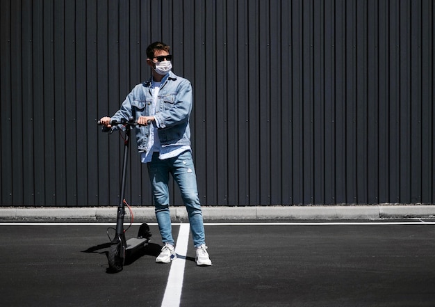 The guy is riding an electric scooter against the background of the city