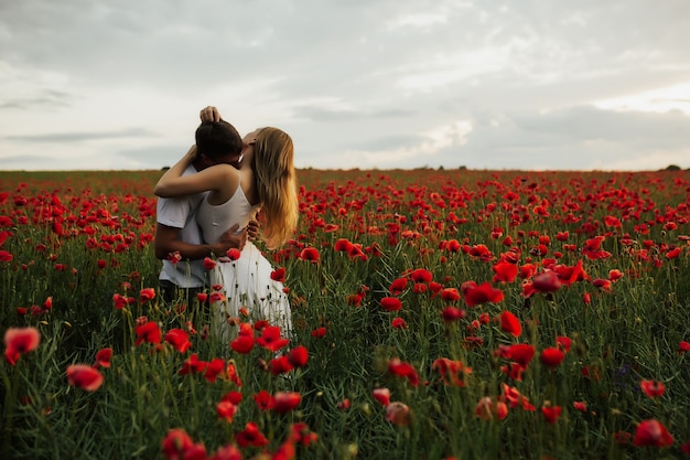 The guy kisses the girl in the neck