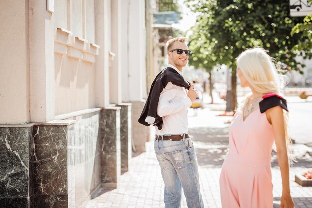 Guy looking at a nice girl passing bywhile walking at the street