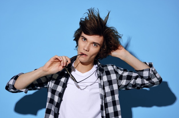 Photo guy in plaid shirt tousled hair glasses fashion posing