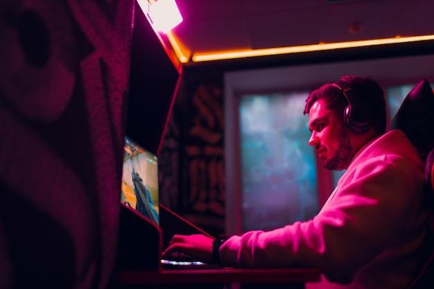 Guy playing gaming game on computer at game club