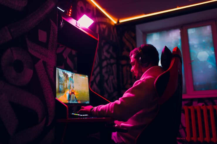 Photo guy playing gaming game on computer at game club