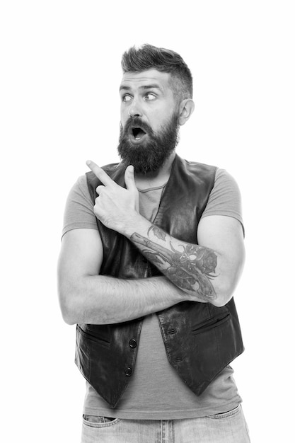 Guy pointing with index finger Barbershop and beard grooming Styling beard and moustache Fashion trend beard grooming Check this out Hipster with beard brutal guy Product recommendation concept