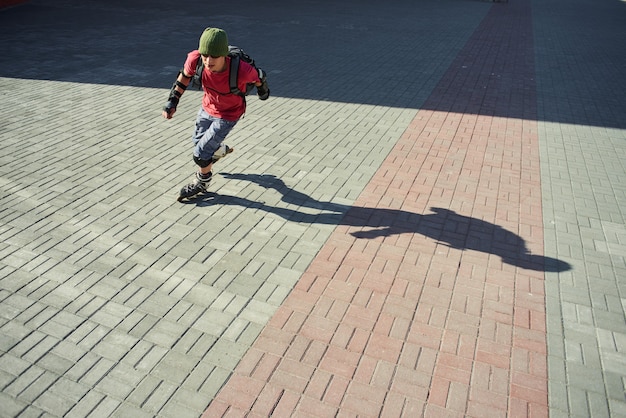 Guy rides on roller skates on the pavement