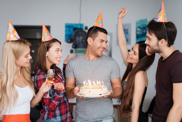 A guy's birthday and his friends congratulate him.