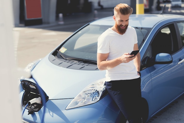 その男は車のボンネットに座った。