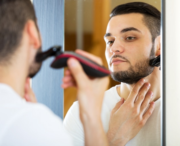 guy shaving by electric shaver