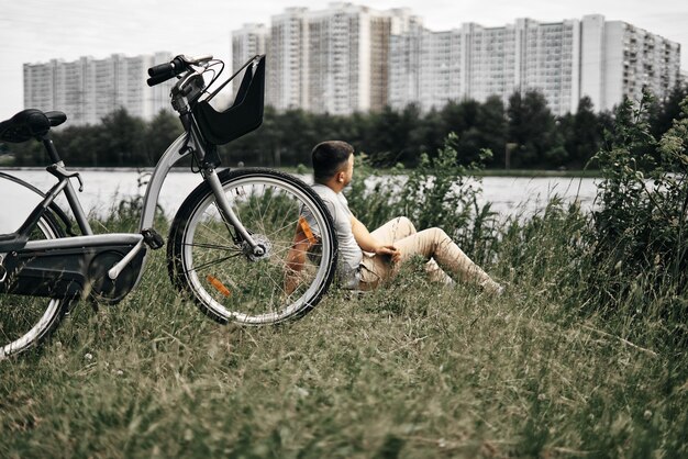 Guy sits in a city park and enjoys nature