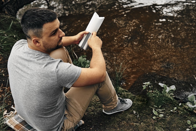 Guy sits in a city park and enjoys nature