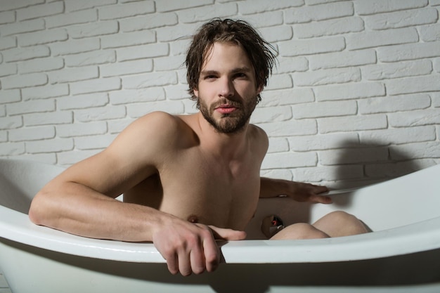 Guy sitting in bath tub