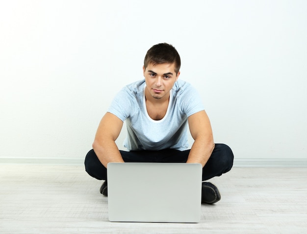 Guy sitting on floor in room