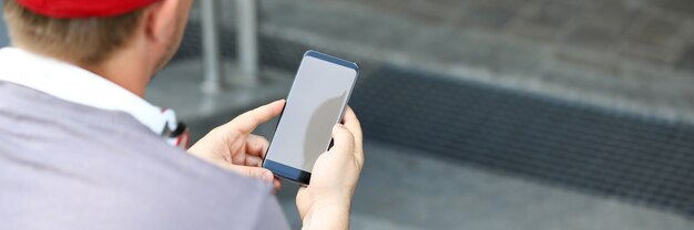 Guy sitting on stairs with cellphone