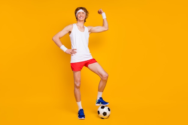 guy sportsman holding leg on ball showing bicep