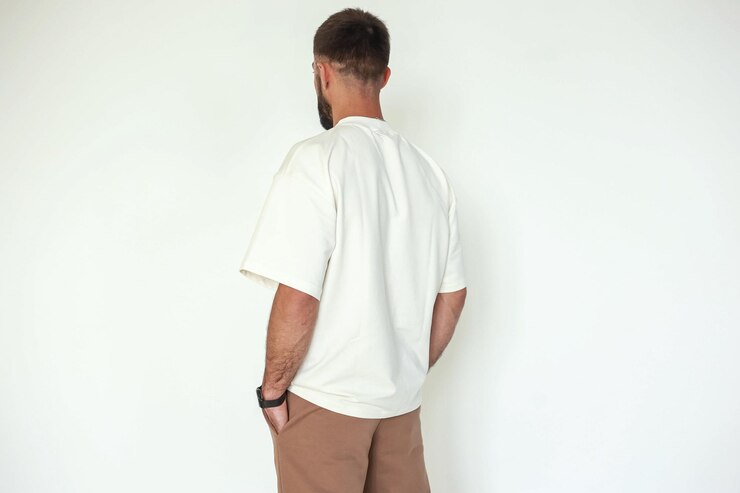 A guy in a stylish, cozy sportswear against a bright background, studio shooting for a magazine, details of fabrics and flowers