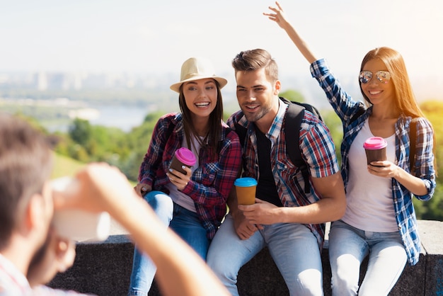 Guy takes pictures of group of tourists.