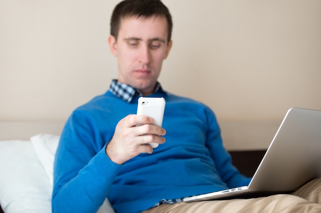 Photo guy using his smartphone while working