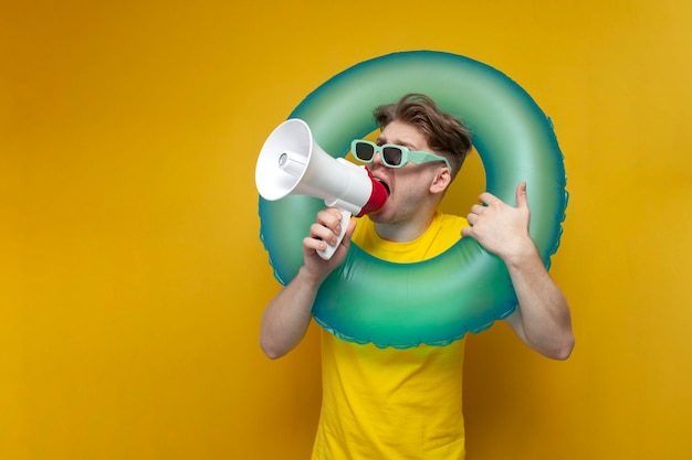 Guy on vacation in the summer shouts and announces the news in a megaphone