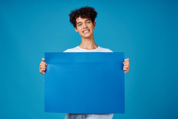 Guy in white tshirt blue poster advertising banner