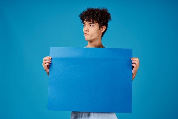 Photo guy in a white tshirt holding a poster mockup advertising high quality photo