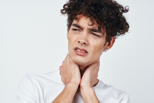 Guy in white tshirt and joint pain health problems studio